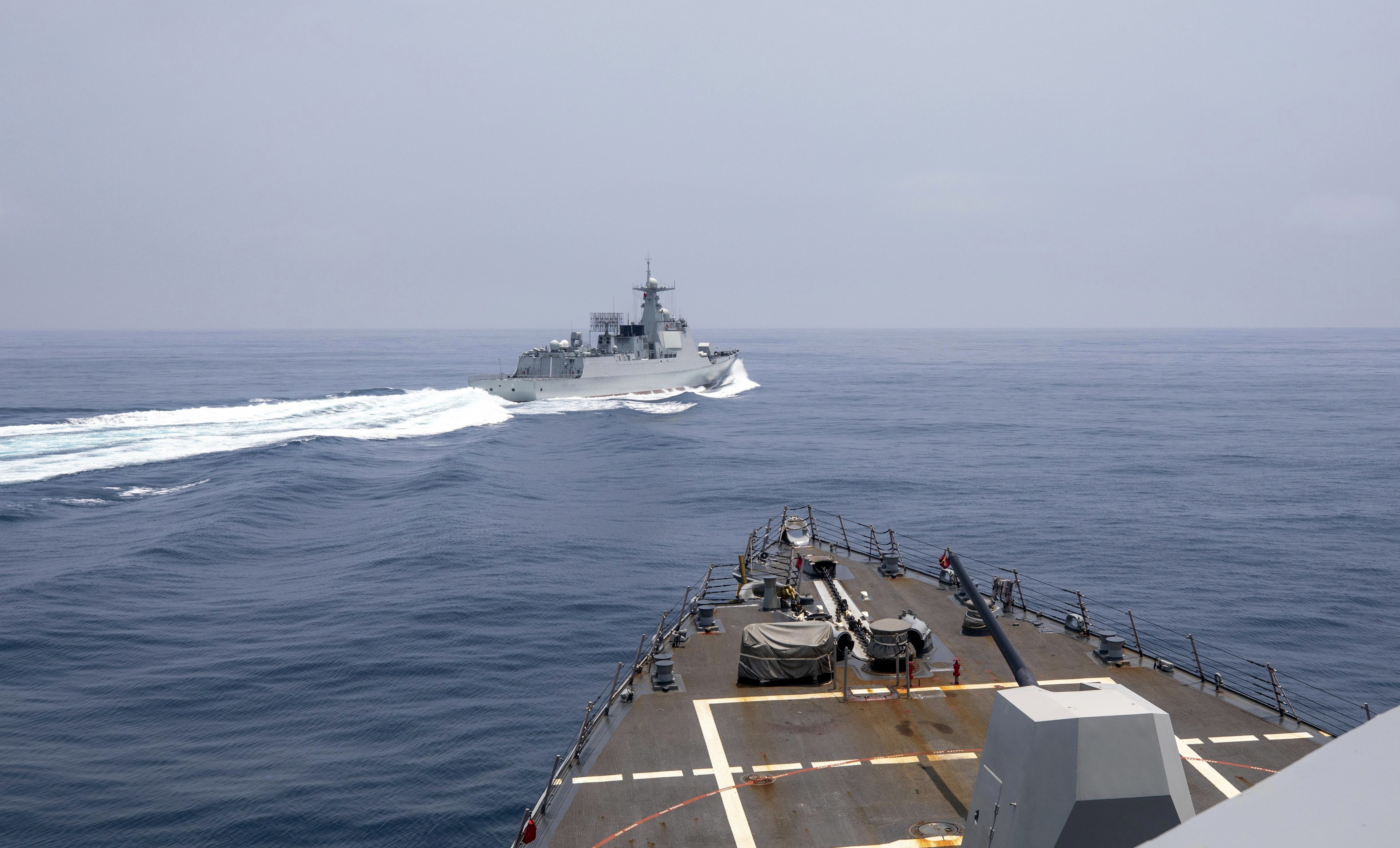 In this photo provided by the U.S. Navy, the guided-missile destroyer Chung-Hoon observes a Chinese navy ship conduct what it called an "unsafe” Chinese maneuver in the Taiwan Strait, Saturday, June 3, 2023.